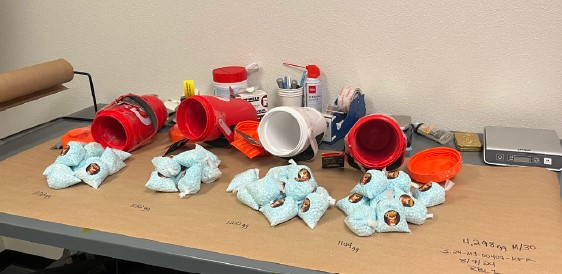 Seized fentanyl pills hidden in drink mix containers