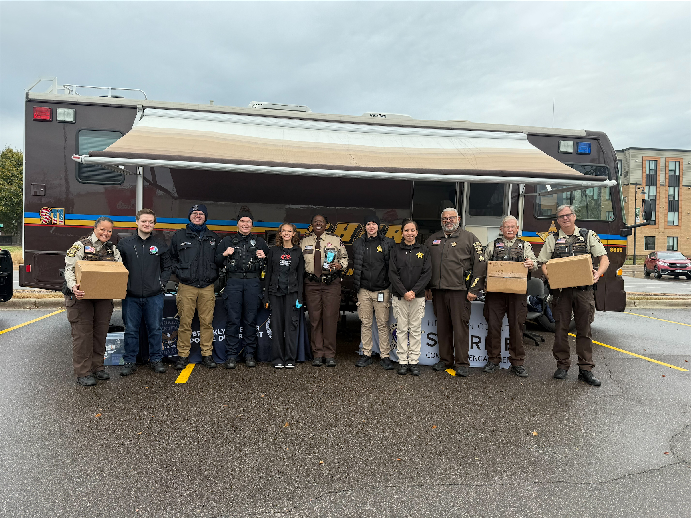 Members of the Hennepin County Sheriff's Office and DEA hold cardboard boxes.