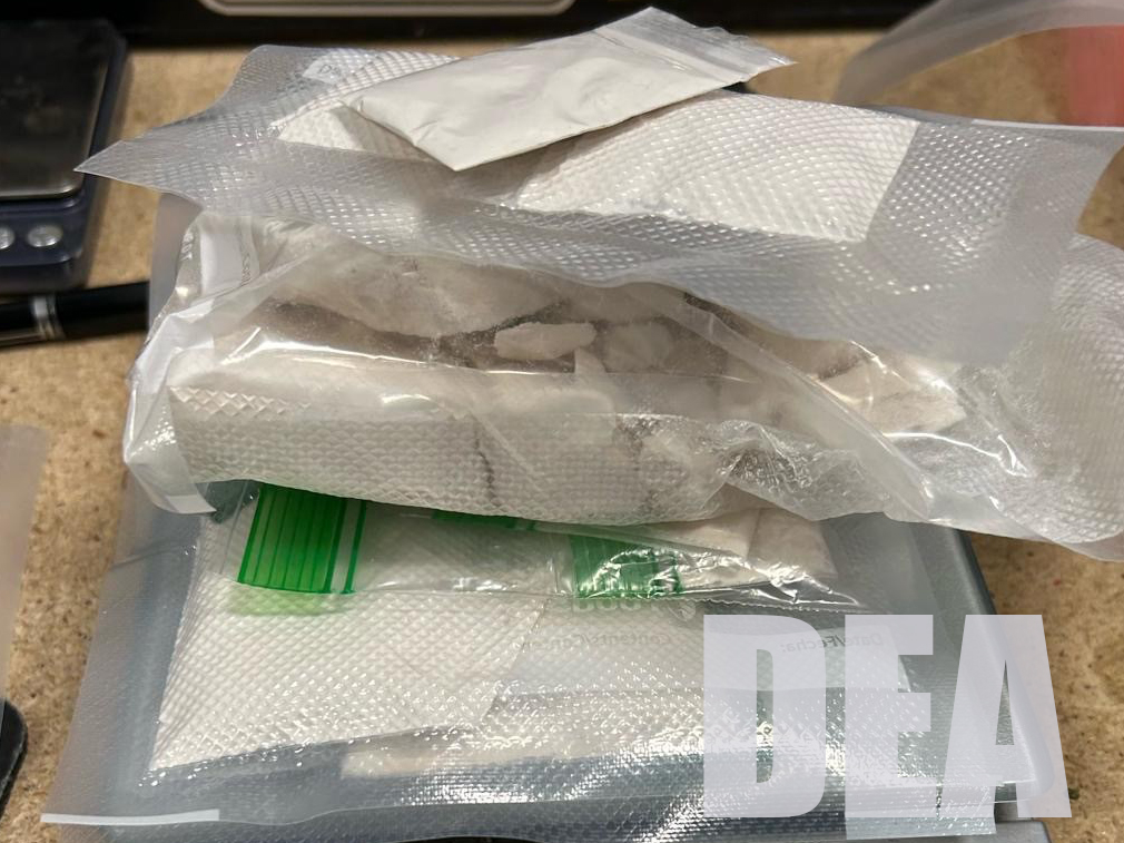Powder fentanyl sits in plastic bags on top of a scale.
