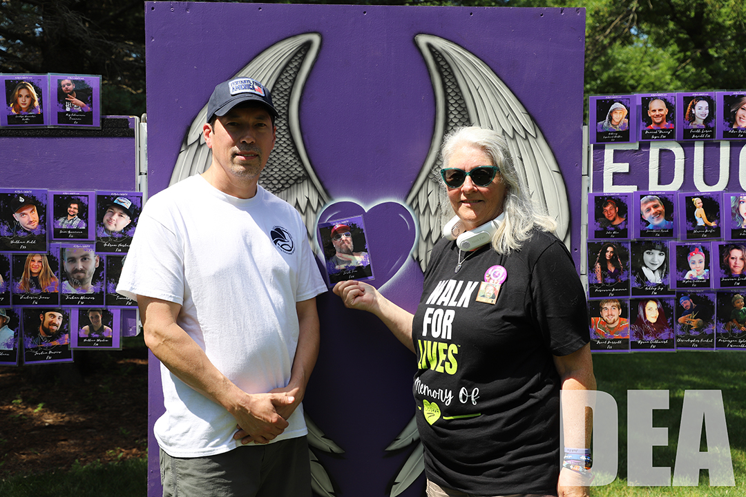 SAC Gillespie stands next to Angel Mom, Malia Fox, holding a photo of her son, Joshua.