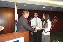 DEA Chicago Group Supervisor David Vargas (left) presents the Scholarship Awards to students Emmanuel Garcia (center) Fatima Garcia (right)