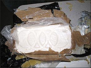 Kilogram of cocaine from seizure shows signature markings.