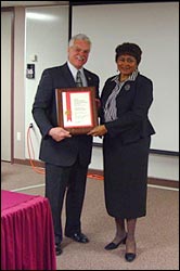 SAC Robert Corso presents an award to Dr. Laura Royster.