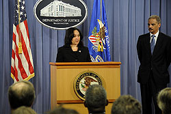 U.S. Attorney General Eric H. Holder Jr. looks on as DEA Acting Administrator Michele M. Leonhart announces the results of Operation Xcellerator.