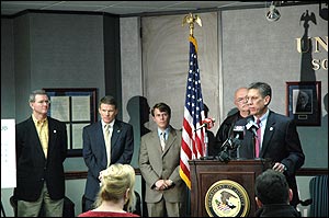A pickup truck towing a goose neck trailer (left)
