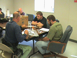 Jackson District Office SA Jeff Jackson, TFA Tony Johnson, and Mississippi Bureau of Narcotics agent Brandon Ladner process seized evidence at command post.