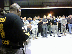 SA Terry Davis addresses over 100 federal, state, and local officers at a pre-dawn briefing session in advance of arrests and execution of search warrants.