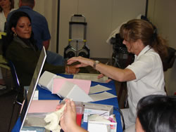 DEA employee and Committee Member Karen Durand, (wearing the dark blouse), participates in the Ochsner Health Fair cholesterol screening.