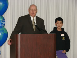 ASAC Pat Warner introduces Eric Le, Essay Winner and 8th Grader from Haynes Academy for Advanced Studies.