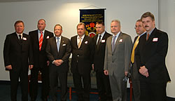 photo- SAC Gilbride and the Russian Delegation pose in front of a Russian Flag that signifies the Federal Service of the Russian Federation for control in the battle of narcotics.