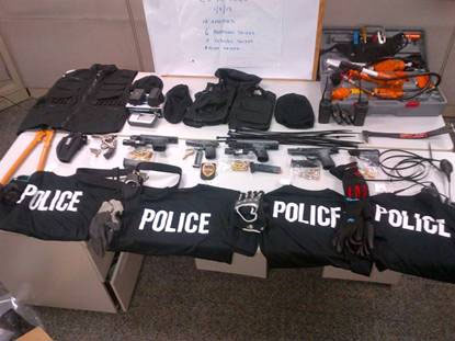 Guns, tactical vests, police shirts, hydraulic ram, police scanner, handcuffs, zip-ties, bolt-cutters, walkie-talkies, ski masks and GPS