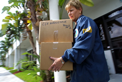 A DEA Diversion investigator seizing items from C&H Wholesale