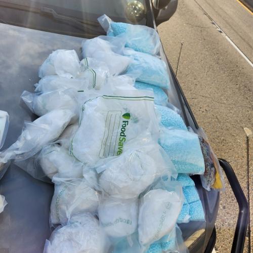 Seized fentanyl and meth on hood of car
