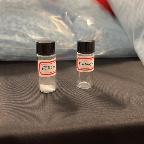 Two tiny vials for display purposes: one showing a fatal amount of heroin, the other a fatal amount of fentanyl