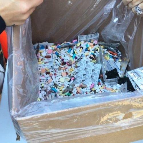 Prescription medications sit inside a collection container.