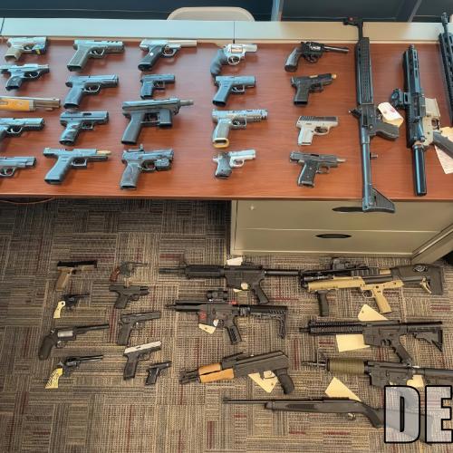 Seized guns displayed on a table