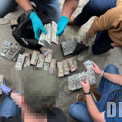 Agents counting cash on the ground