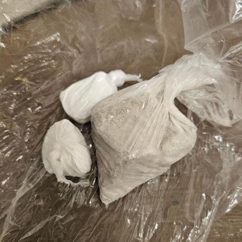 three baggies on a table filled with various colors of powder