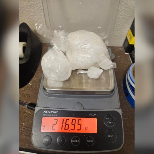 a couple baggies of drugs on a scale