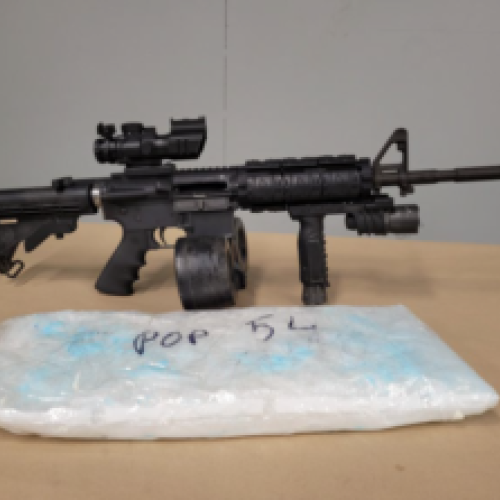 Seized Colt AR15 rifle with drum magazine.