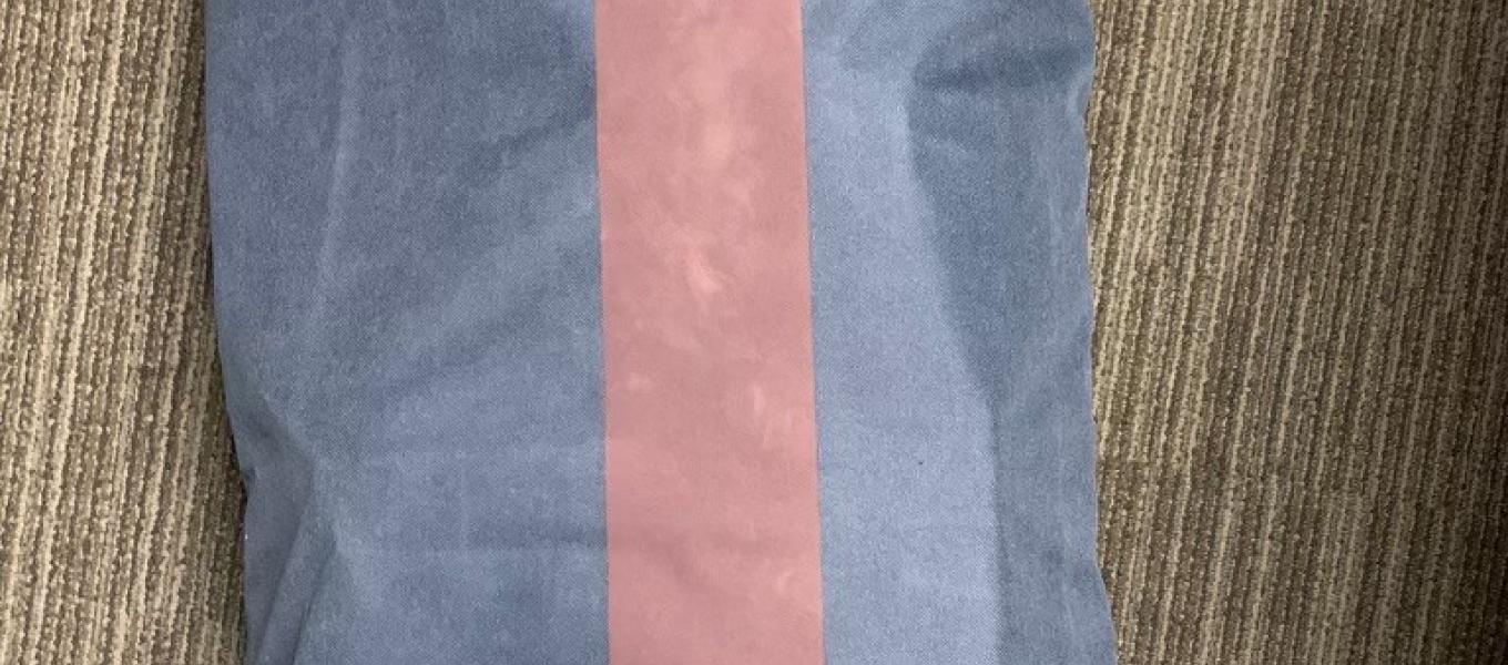 Blue rolling suitcase used to transport 50,000 glassines filled with fentanyl