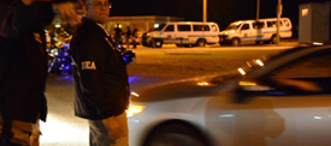 DEA agent directs PRPD-DEA Task Force Lieutenant Jorge Estrada to an arrest location.