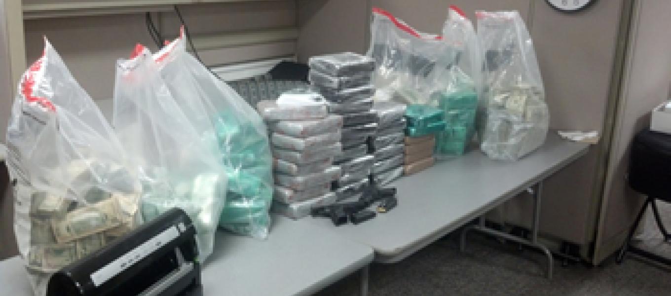 Drugs, weapons, and money seized as a result of the investigation.