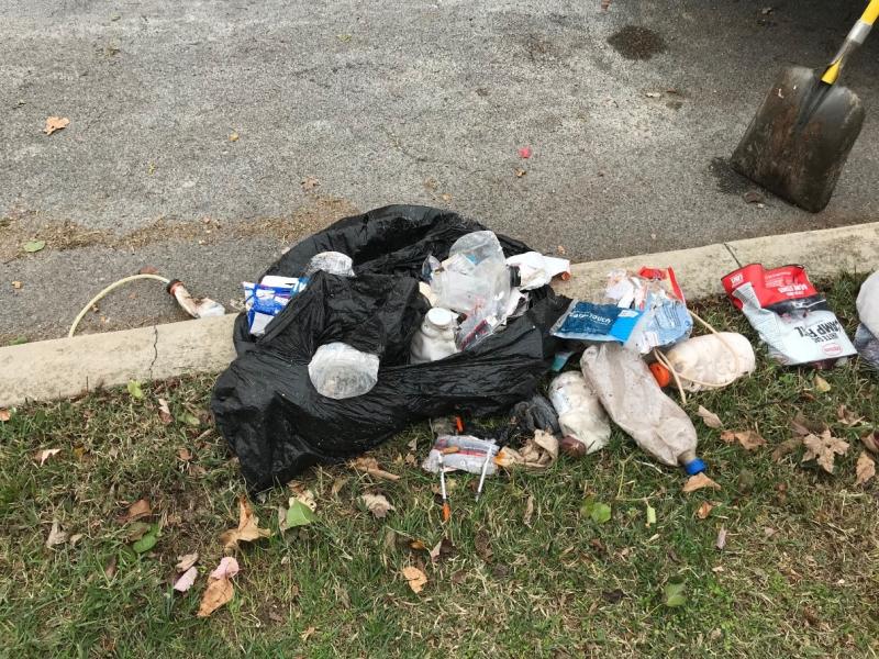 A trash bag containing approximately 14 “one-pot” meth production devices and materials