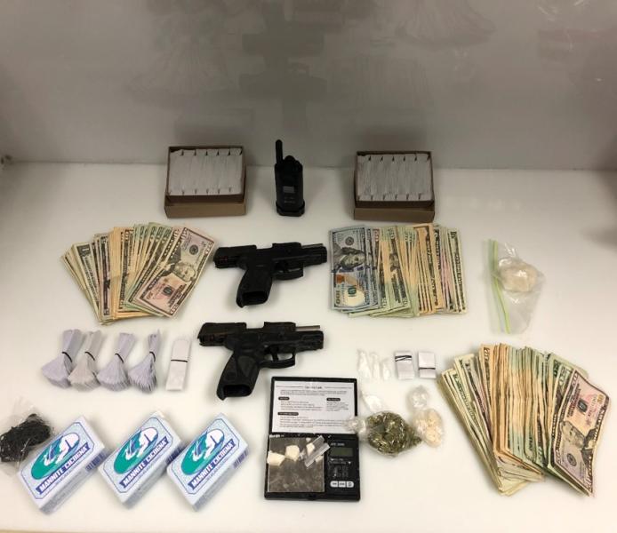 Guns, money and drugs on a table
