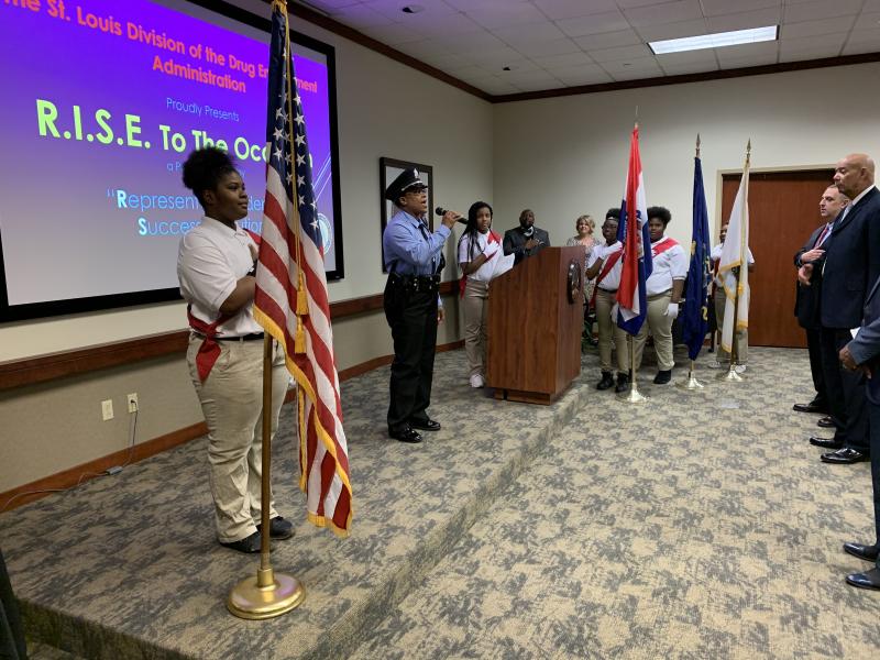 Girl Scout Troop 196 listens to the National Anthem.