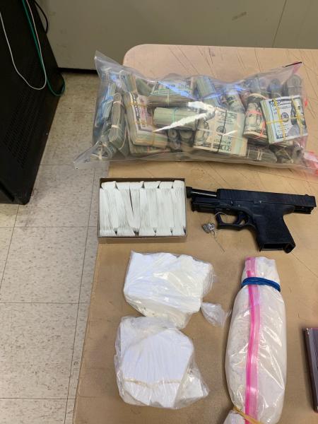 Cocaine, heroin, gun and money seized from stash location
