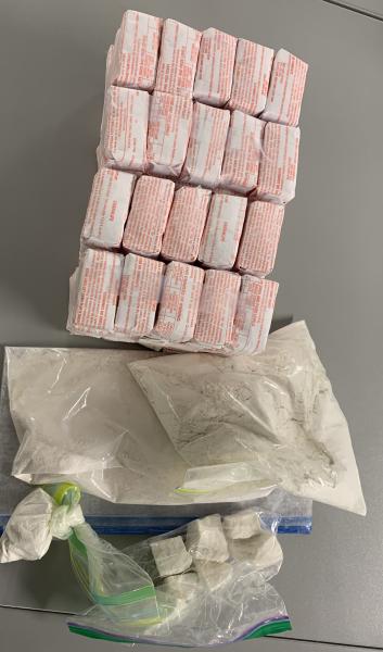 Bundles of suspected heroin/fentanyl glassines and bags of powder