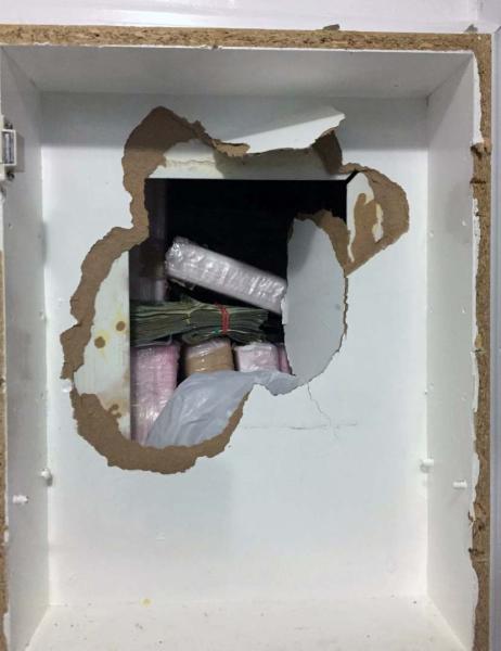 Trafficking organization used concealed compartment behind bathroom medicine cabinet 
