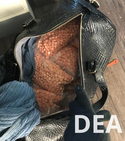 counterfit adderall pills in a large travel bag