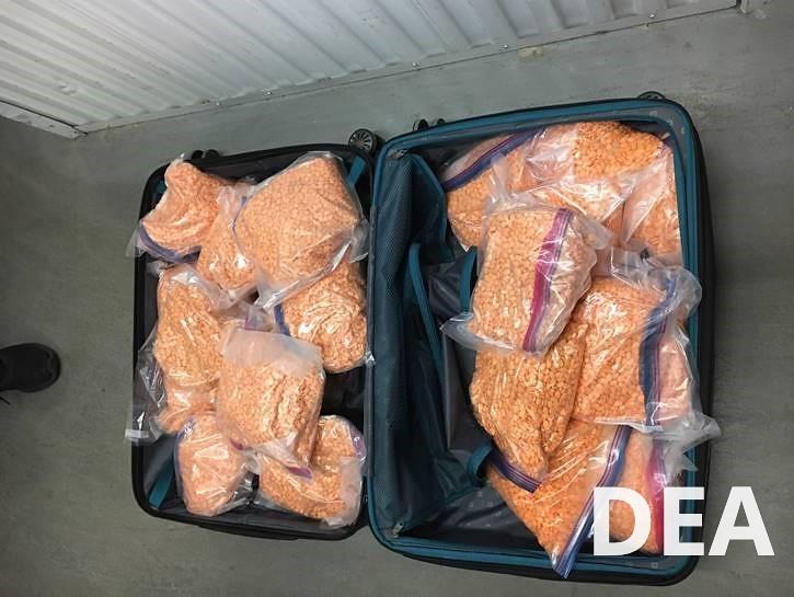 counterfit adderall pills in a suitcase