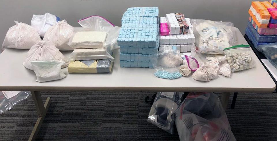 Kilogram-size packages of heroin, fentanyl plls, and glassines seized in enforcement operation