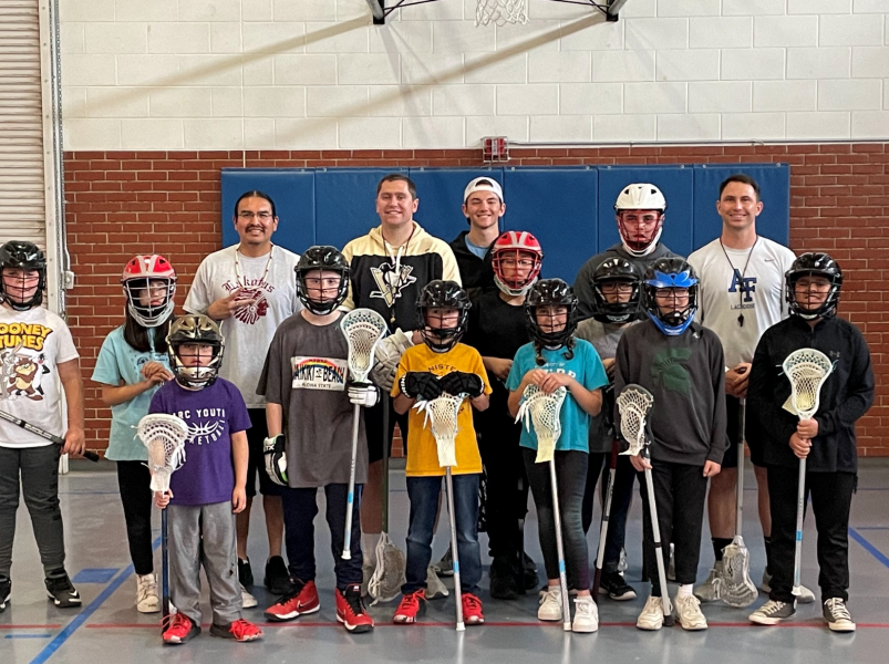 Students and coaches prior to lacrosse practice.
