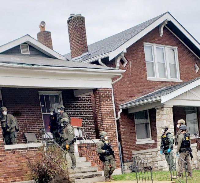 DEA agents serve a search warrant on a St. Louis residence.