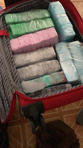 Heroin Fentanyl filled glassines seized in suitcase