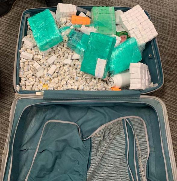Heroin and Fentanyl Glassines seized in suitcase