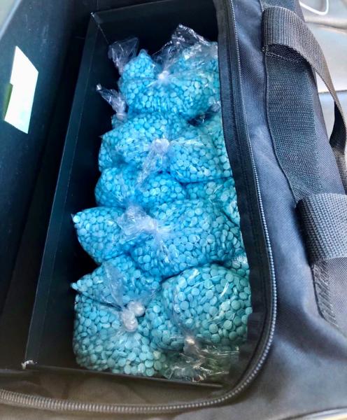 Thousands of fentanyl pills transported in duffle bag.