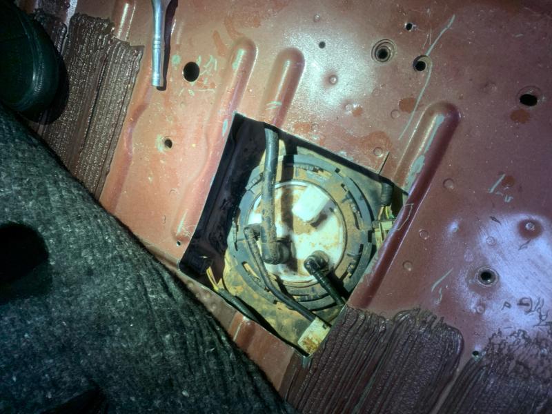 gas tank uncovered under floorboard