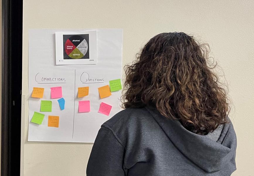 woman looking at notes posted on a wall
