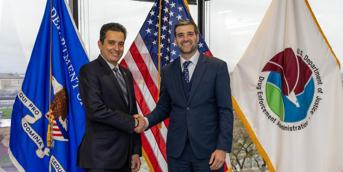 men in blue suits shaking hands
