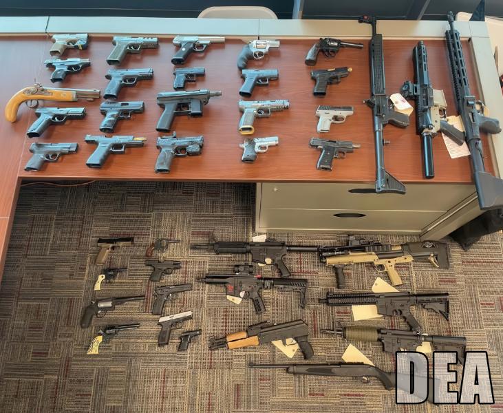 Seized guns displayed on a table
