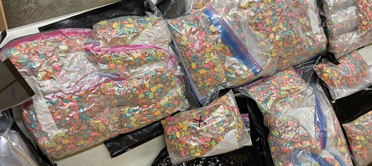 multiple plastic bags of multi-colored pills