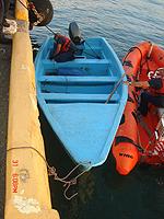 USCG personnel secure the 18’ homemade “yola” to the USCG pier.