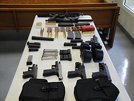 Automatic weapons , magazines, ammunition possessed by convicted felons Julio Pastrana and Alexander Ortiz. They face charges of firearms possession while being convicted felons.