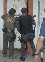 DEA and PRPD agents execute a search warrant at a residence in La Perla. 