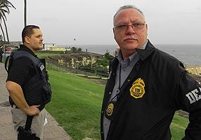 (L-R) PRPD LT Digno Cartagena and DEA SAC Javier F. Peña supervise the progress of the arrest operation near La Perla ward in Old San Juan, PR. 